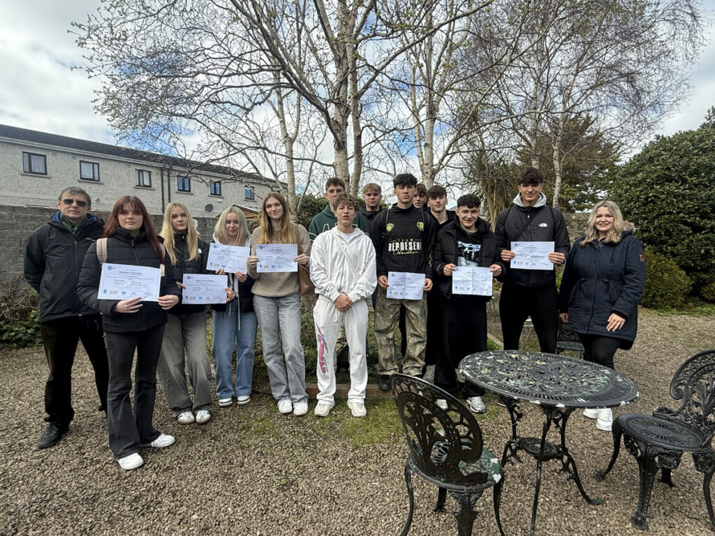 Group with certificates at language school garden